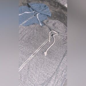 A bundle of two thin hooded sweaters